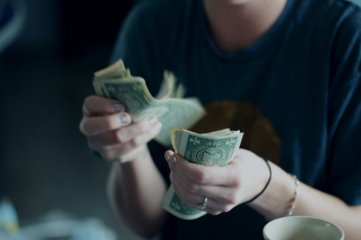 focus-photography-of-person-counting-dollar-banknotes.jpg focus photography of person counting dollar banknotes